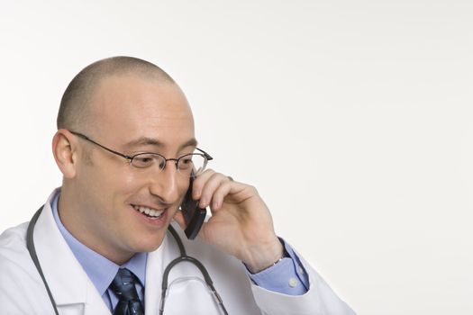 Caucasian mid adult male physician talking on cellphone.