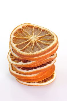 A stack of dried orange slices on bright background