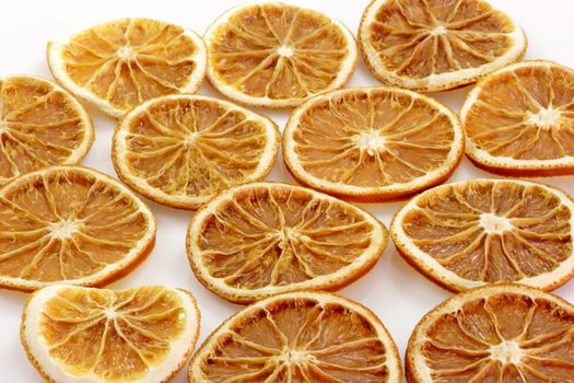 Close up of dried orange slices on bright background