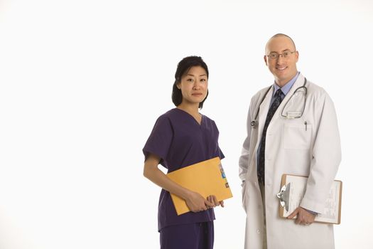 Caucasian mid adult male physician with Asian woman doctor.