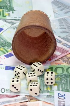 Dice shaker with dices on Euro notes