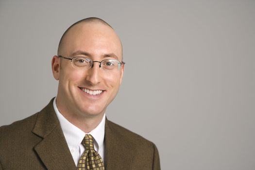 Head and shoulder portrait of smiling mid adult Caucasian businessman.