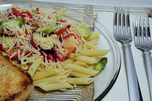 Penne Pasta with assorted vegetables topped with Asiago cheese