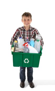 A child holds a recycling bin container full of tins, bottles and papers suitable for recycling.  White background.