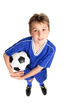 A boy in soccer uniform holding a soccer ball.  White background.