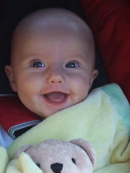Baby caucasian girl smiling to her parents