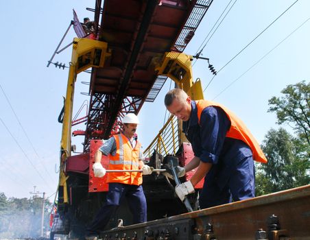 KYIV REGION, UKRAINE - AUGUST 21: Repair workers modernize the 1, 000th km of Irpin-Bucha railway line on August 21, 2007  in Kyiv region, Ukraine