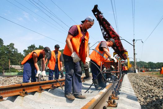 KYIV REGION, UKRAINE - AUGUST 21: Repair workers modernize the 1, 000th km of Irpin-Bucha railway line on August 21, 2007  in Kyiv region, Ukraine