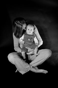 Baby caucasian girl sitting on mother's lap