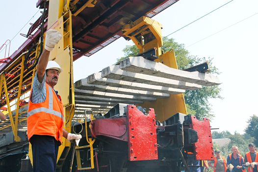 KYIV REGION, UKRAINE - AUGUST 21: Repair workers modernize the 1, 000th km of Irpin-Bucha railway line on August 21, 2007  in Kyiv region, Ukraine