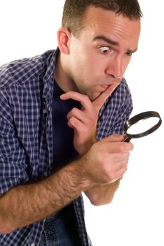 A young man with a magnifying glass searching for something