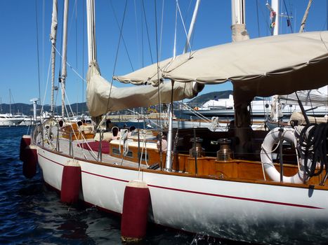 Side with buoys of a big white and brown boat made of wood by beautiful weather