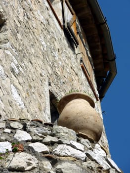 Brown pottery standing on the wall of a house in Eze historical village, south of France
