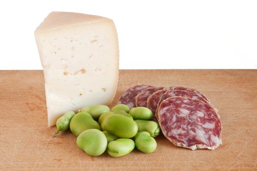 cutting board with salami pecorino and broad beans isolated on white background with clipping path