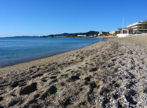 Beach of sand and mediterranean sea at Lavandou, south of France, by beautiful weather