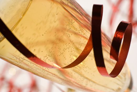 Champagne flute detail with ribbon - shallow dof, focus on the bubbles.