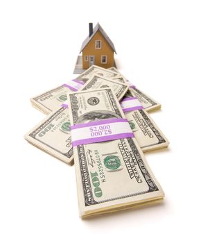 Home and Stacks of Money Isolated on a White Background