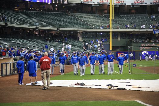 Chicago Cubs baseball players enter the field for batting practice before a game with the Brewers
