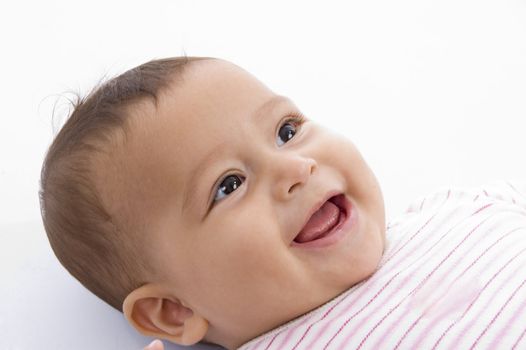 close up of smiling cute baby against white background