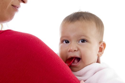 close up of cute little baby with mother against white background