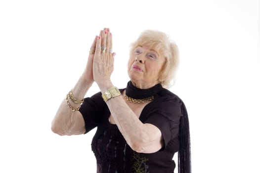 praying old woman against white background