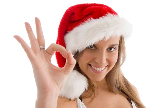 model with christmas hat and showing ok sign on an isolated white background