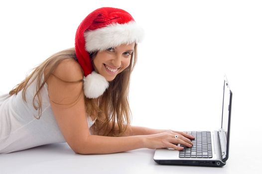 laying female with christmas hat and laptop against white background