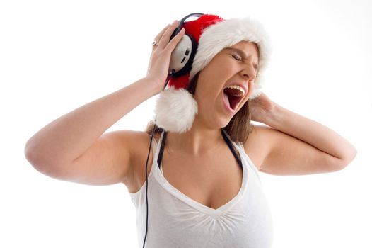 woman wearing christmas hat and enjoying music with white background