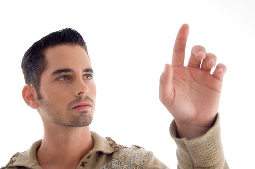 cool young guy pointing upwards against white background