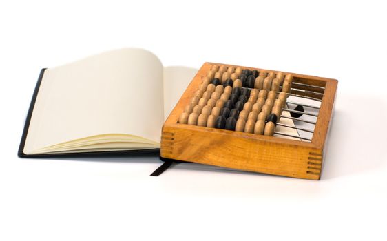 Open notebook and old wooden abacus on a white background.