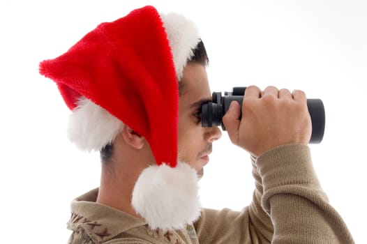 handsome guy looking into binoculars and surprised on an isolated white background
