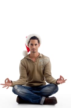 handsome man wearing christmas hat and doing meditation on an isolated white background