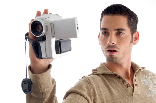 young man looking in to video from handy cam on an isolated white background