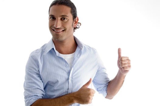 smiling male model with thumbs up against white background