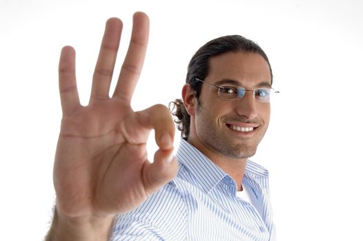 young caucasian man with ok symbol against white background