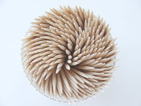 Open plastic box of wooden toothpicks close up