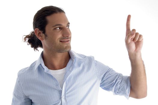 young caucasian man pointing upwards against white background