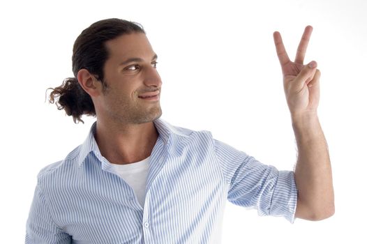 handsome model gesturing victory on an isolated background