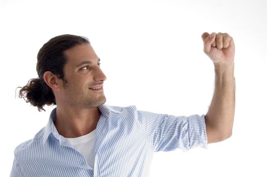 handsome model showing fist in air against white background