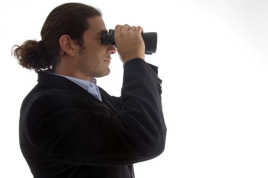 young caucasian service provider looking through binoculars against white background