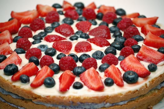 Fruit cake dessert. Garnished with strawberries, blackberries, raspberries