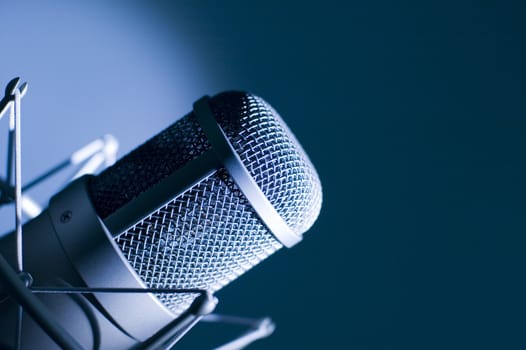 Microphone in studio. Dark blue light.