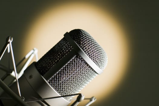 Microphone in studio. Yellow light.