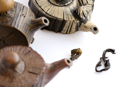 A close up view of Chinese ceramic teapots over white