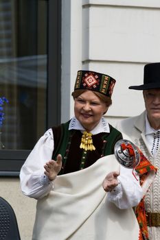Ex-President of the Republic of Latvia Vaira Vike-Freiberga wearing traditional costume greets the participants of the procession of the Song and Dance Celebration festival in Riga, Latvia, July 6, 2008