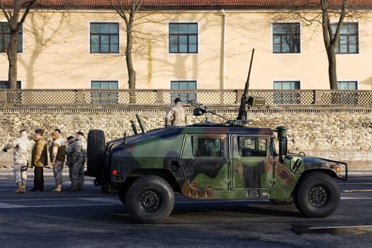 NATO (Latvian) soldiers at military car waiting for the Military parade of the National Armed Forces. 90th anniversary of establishment of the Republic of Latvia. Riga, Latvia, November 18, 2008