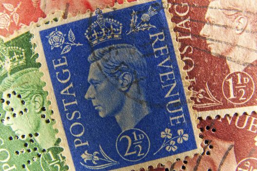 Vintage postage stamps from United Kingdom, face of King George.