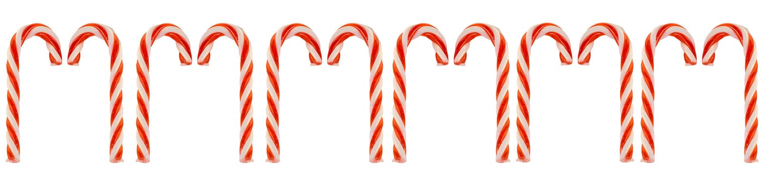A row of candy canes isolated against a white background