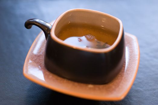 Jasmine fresh tea - focus on the liquid surface, shallow depth of field.