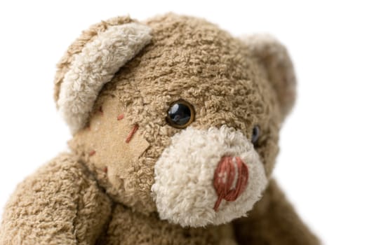 Patched teddy bear portrait - selective focus on the eye.